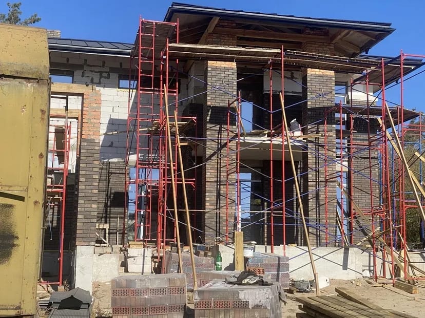 Мурування цегли. Бригада будівельників. Будівництво будинків.